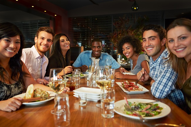 Group Of Friends Enjoying Meal In Restaurant